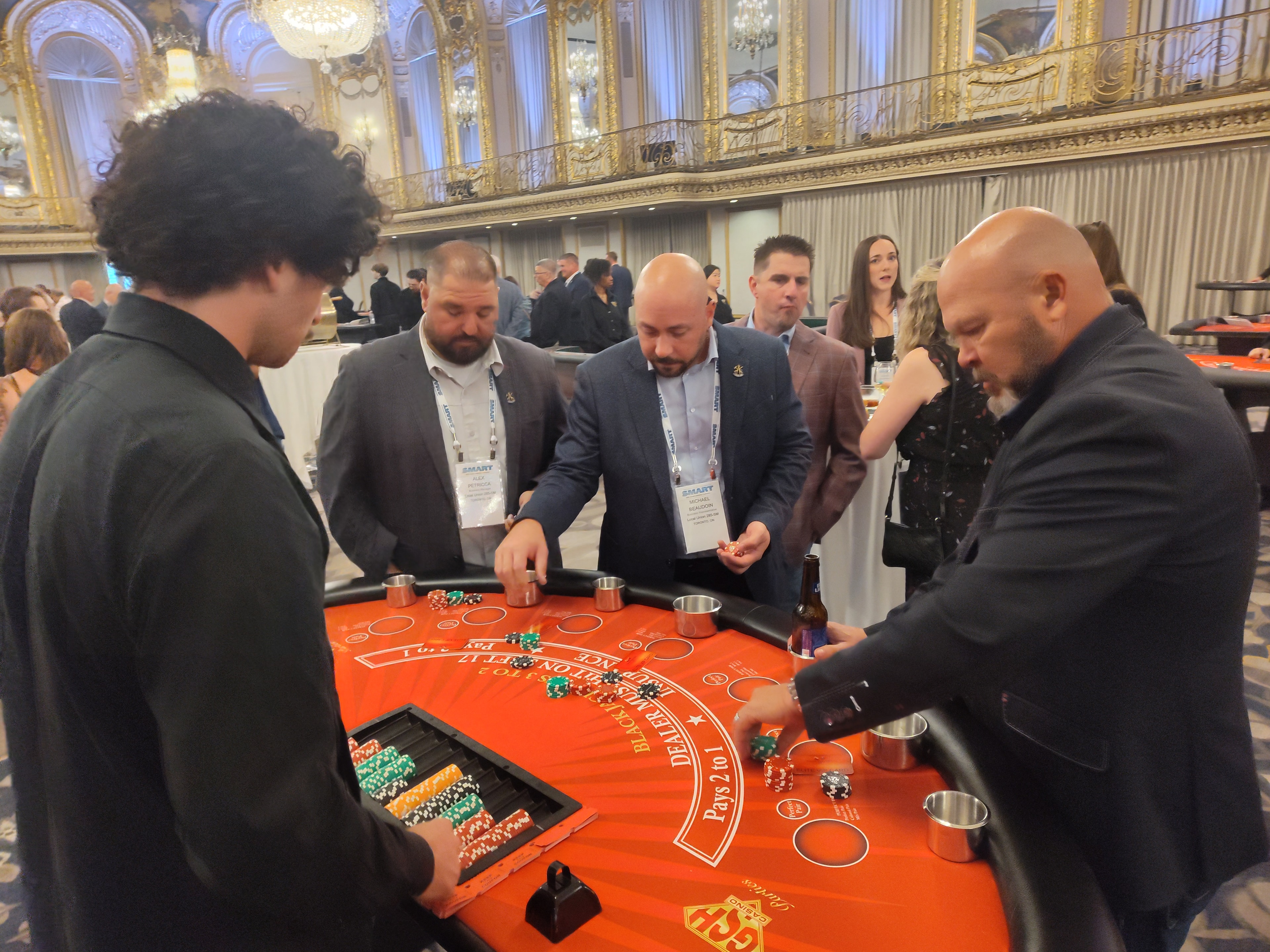 Conference attendees playing blackjack at Casino Party USA table inside the Hilton Chicago