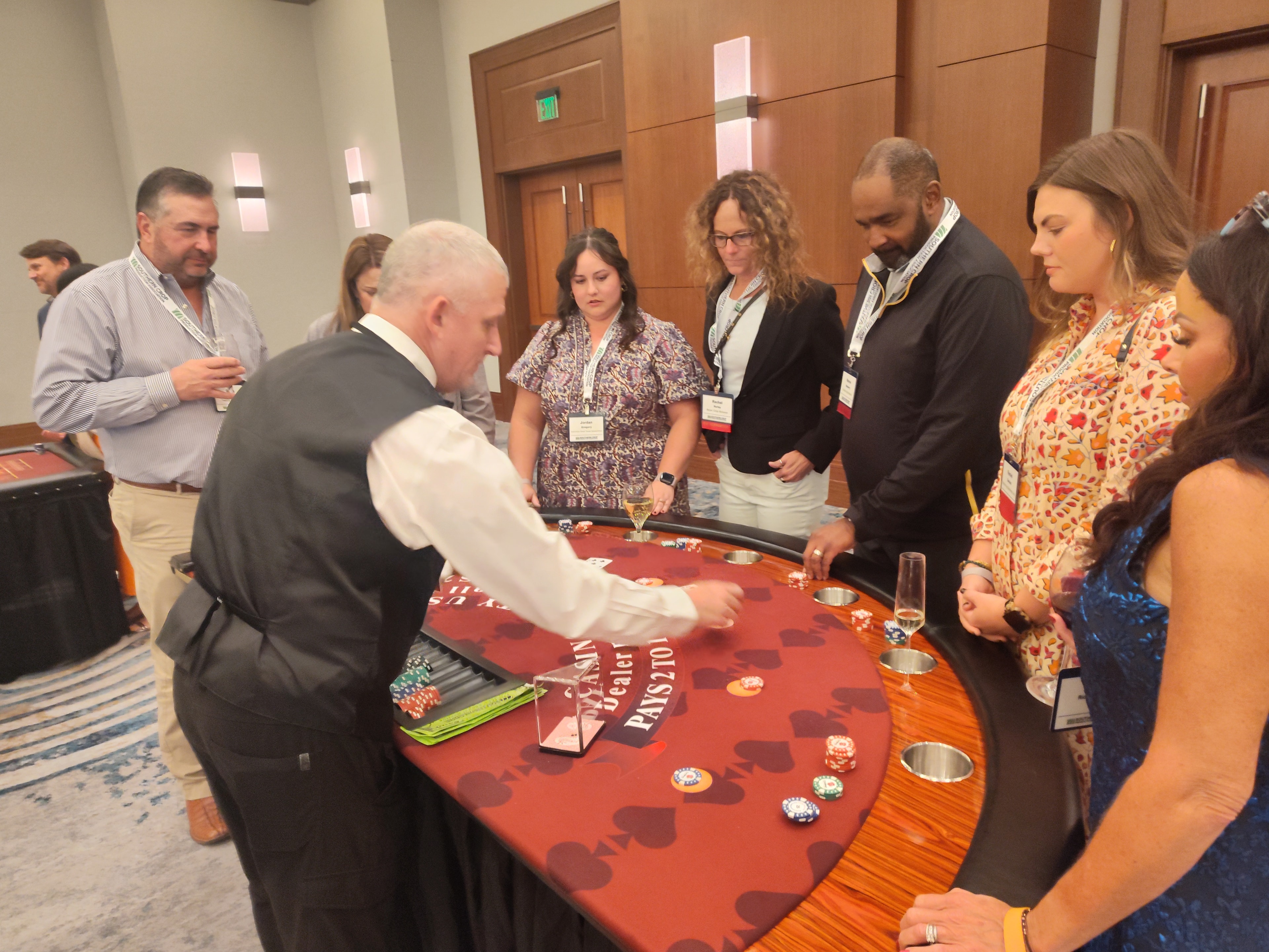 Casino Party USA dealer dealing cards to a group of guests at a Jacksonville event