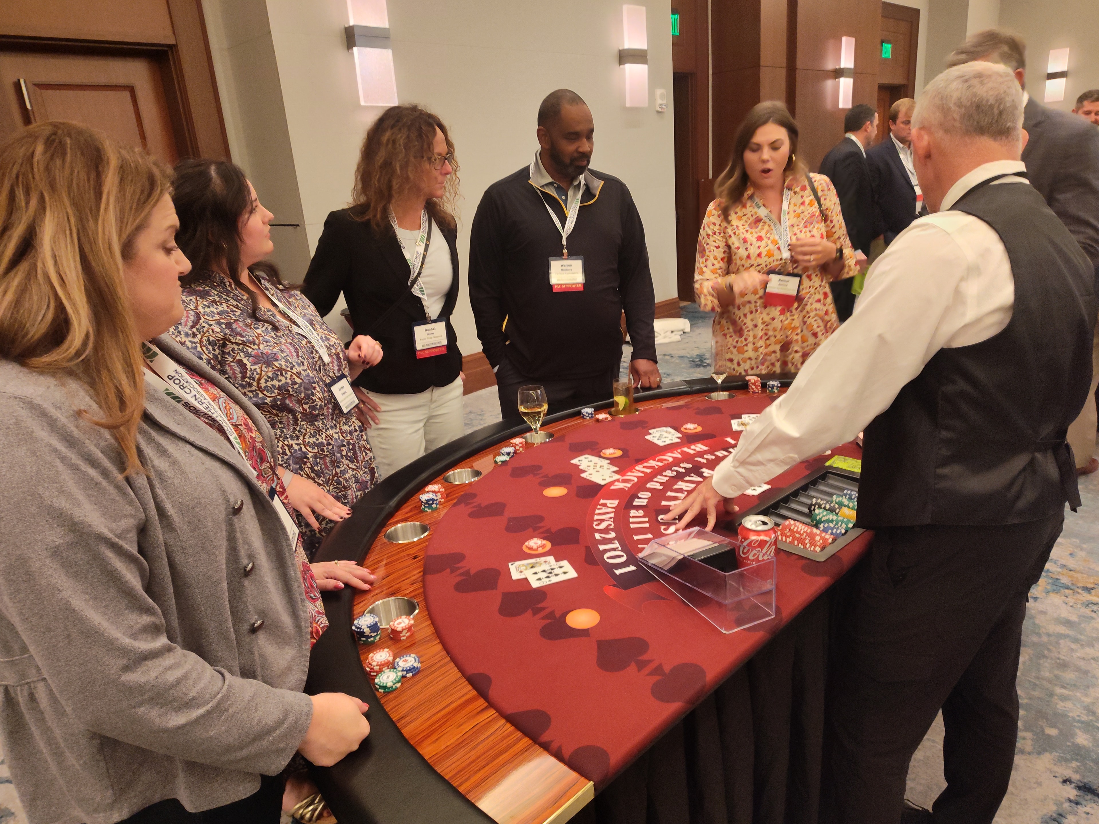 Casino Party USA dealer and guests at a red blackjack table at a Jacksonville event