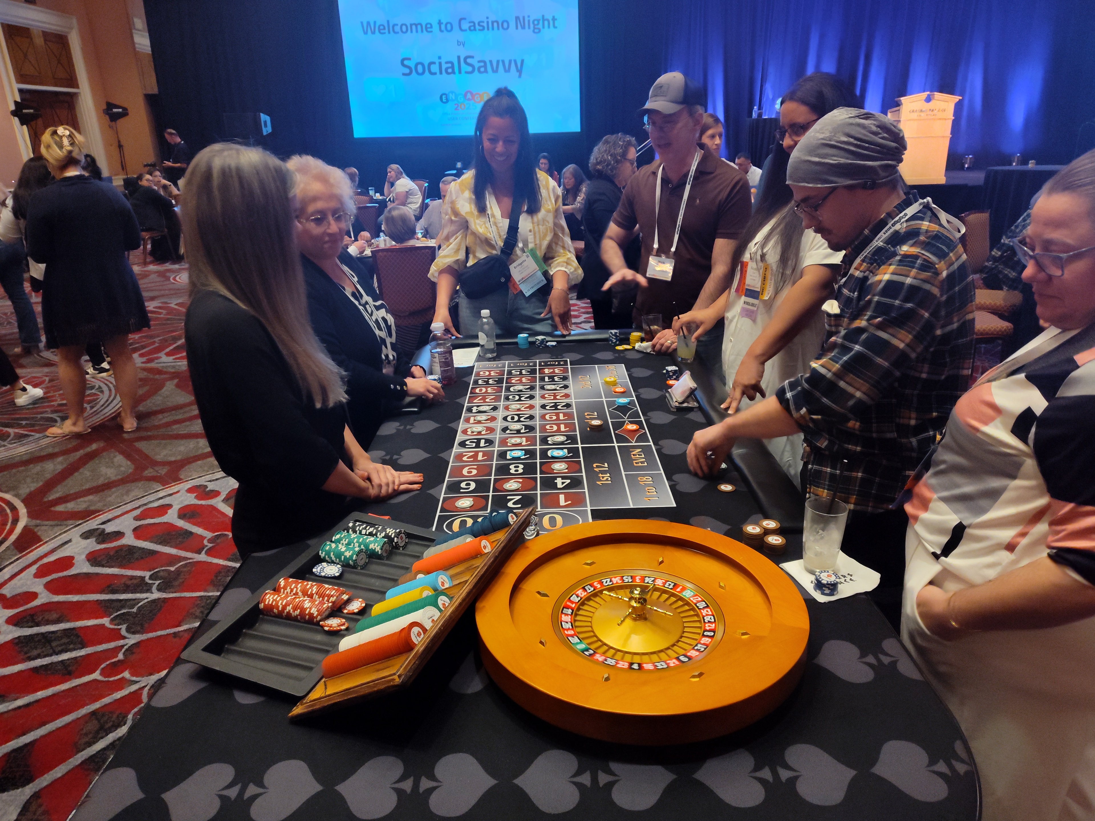 Guests crowded around a roulette table at a SocialSavvy Casino Night by Casino Party USA in Las Vegas