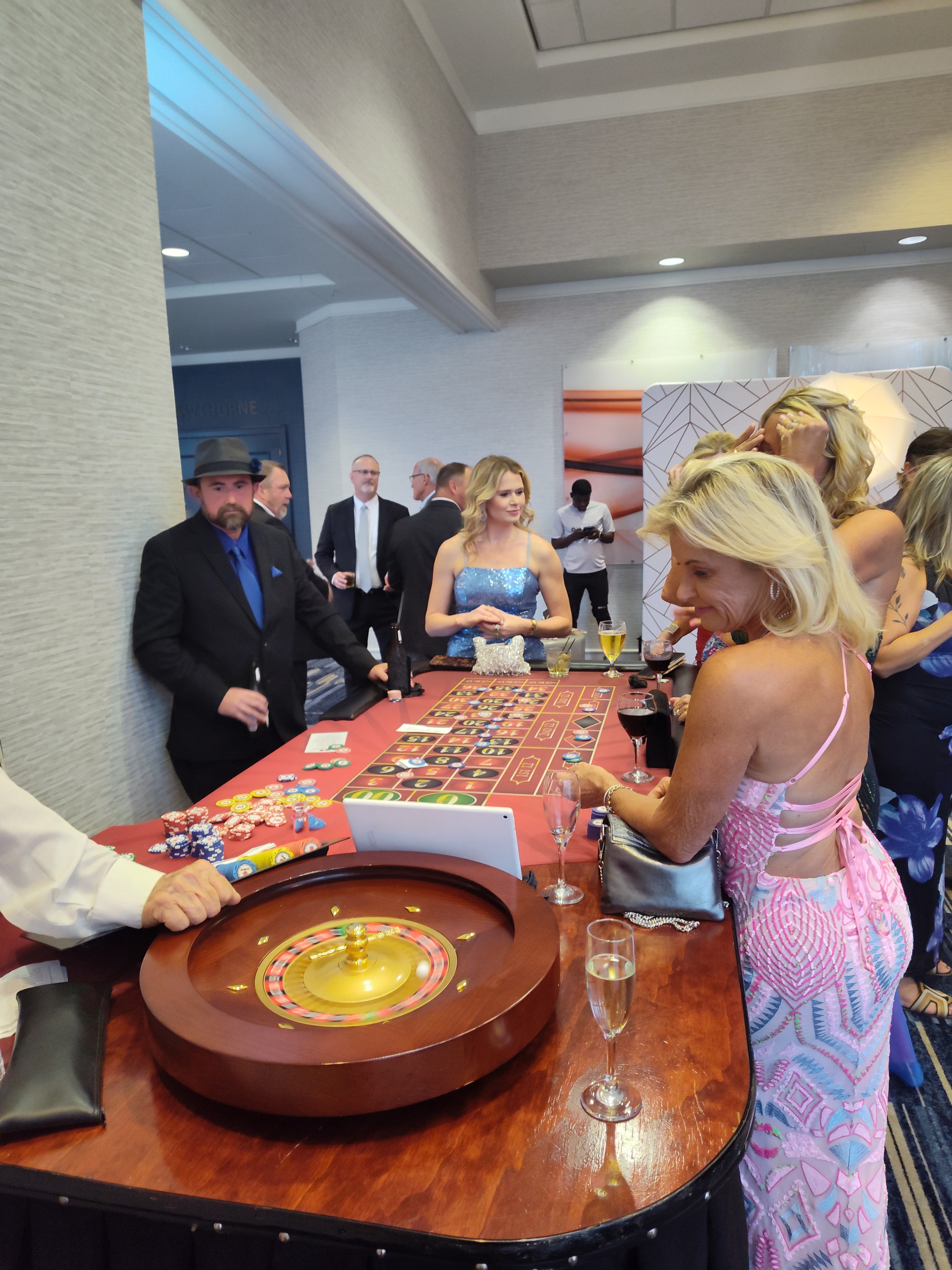 Guests gathered around a Casino Party USA roulette table at an Omaha event