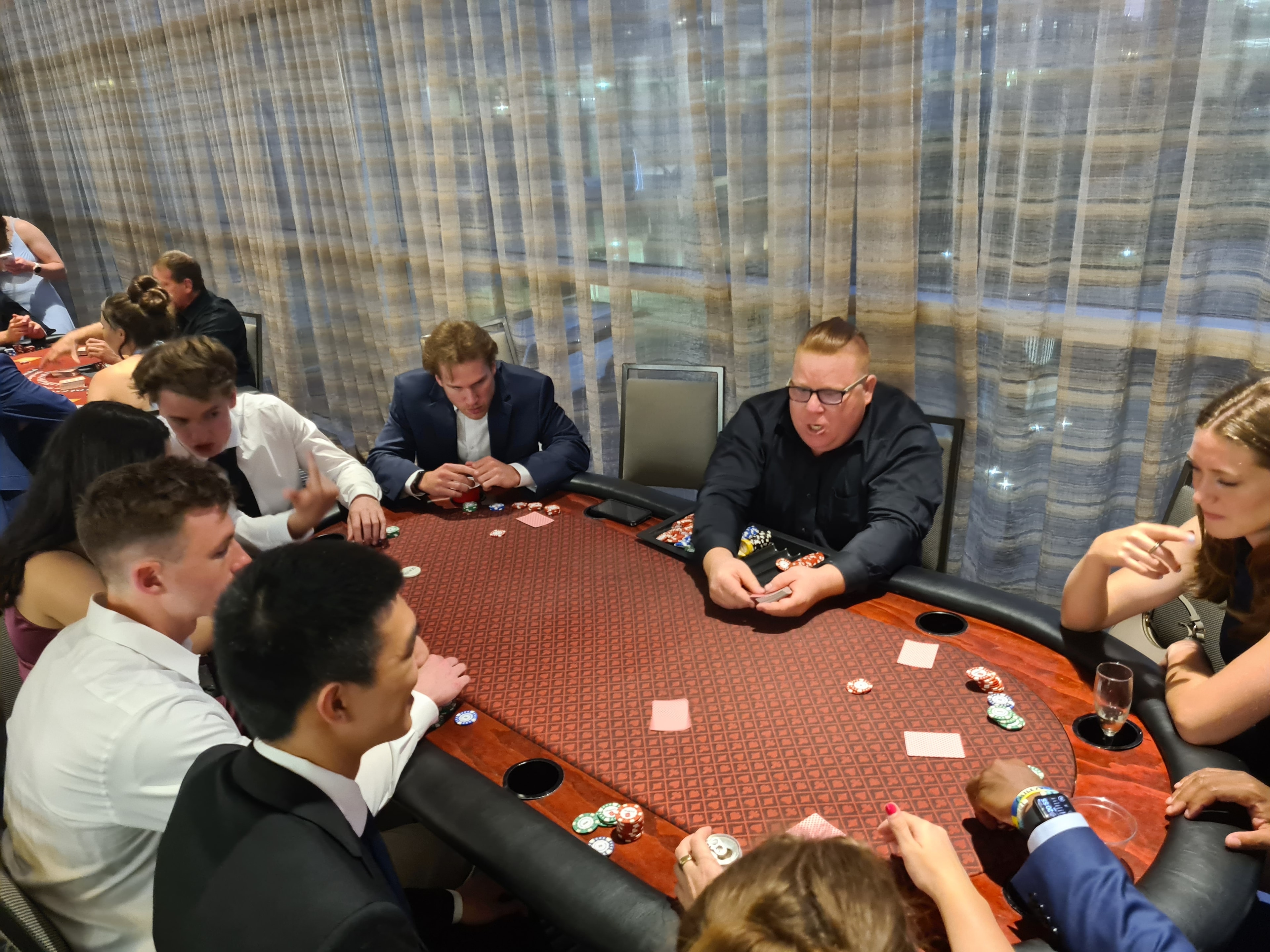 Guests playing poker in a private room at an Omaha Casino Party USA event