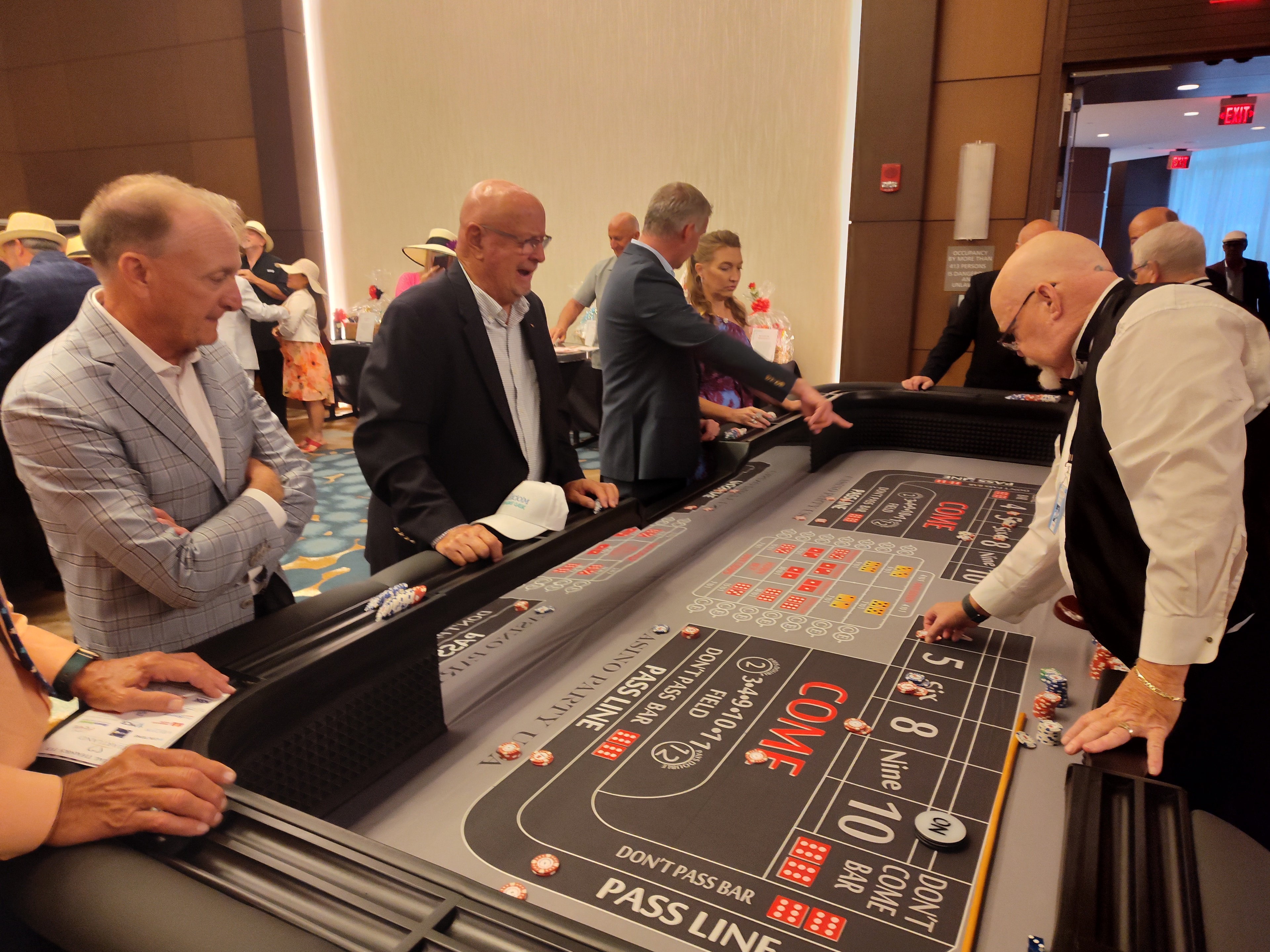 Guests at a Casino Party USA craps table in a large ballroom at an Orlando event