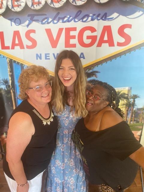 Guests posing in front of the Las Vegas backdrop at a Casino Party USA selfie station