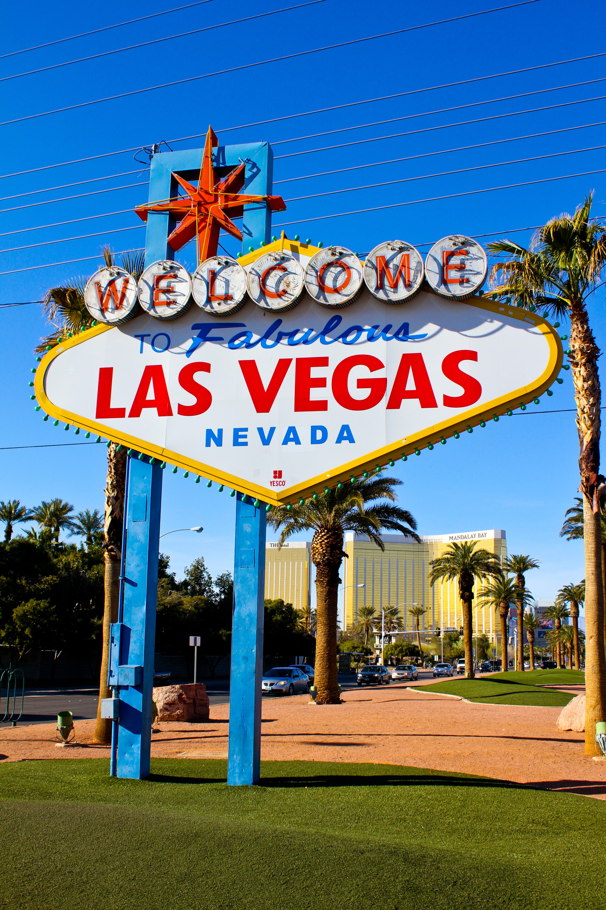 Iconic Welcome to Fabulous Las Vegas Nevada sign with palm trees and blue sky