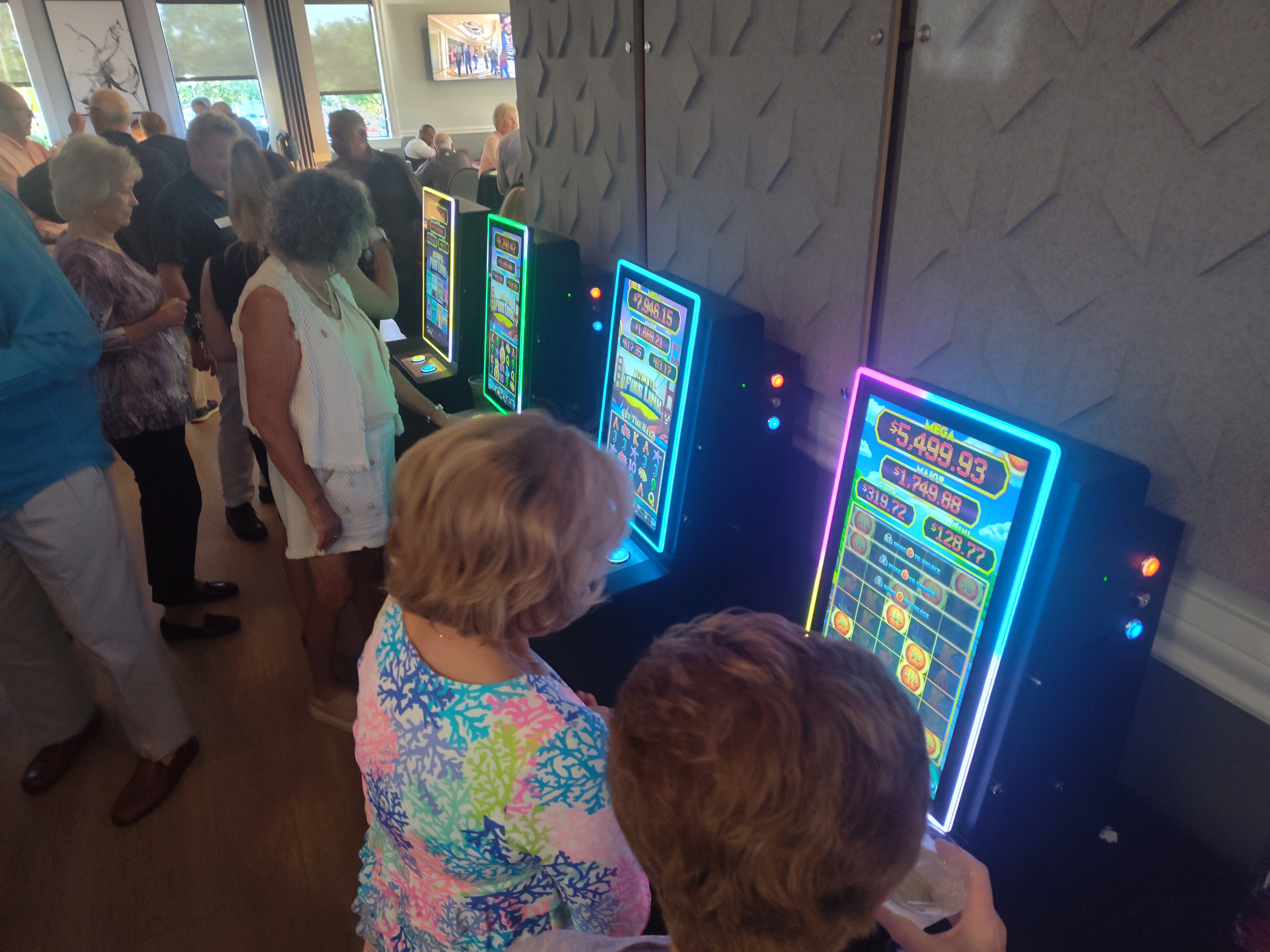 Guests playing Ultimate Fire Link slot machines at a Casino Party USA event