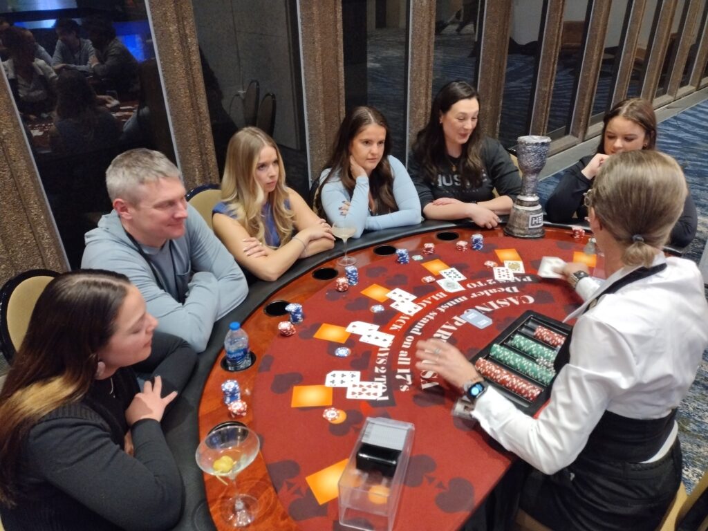 Guests at a red poker table